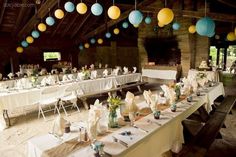 tables set up for a party with paper lanterns