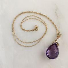 Details: Lovely vintage amethyst pendant and 14K gold necklace. The amethyst is faceted, and has an amazing sparkle glow. The amethyst measures 15.19 x 19.67 x 10.37mm, and is roughly 14.5 carats. This pendant is sold with a 14K gold chain, and the chain is modern. Please ask all necessary questions prior to placing an order! Size: The chain measures 16 inches, and the pendant is 1 1/4 inches. Condition: The overall all condition of this piece is very good. Classic Amethyst Purple Necklace, Purple Drop Necklace For Formal Occasions, Classic Purple Amethyst Necklace, Formal Purple Drop Necklace, Formal Purple 14k Gold Necklace, Classic Amethyst Pendant Necklace, Formal Yellow Gold Amethyst Necklace, Lavender Gemstone Necklace For Formal Occasions, Formal Amethyst Birthstone Necklace