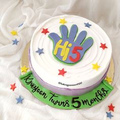 a birthday cake with the number thirteen on it and stars around it, sitting on a white blanket