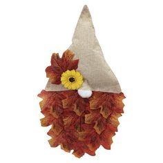 an orange and yellow fall leaf decoration with a sunflower on it's head