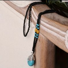 Bohemian Style Beaded Necklace With Turquoise Pendant. Ethnic Pendant Necklace. Seed Beads. Synthetic Stone. Turquoise Beaded Necklaces With Black Beads For Festival, Turquoise And Black Beads Necklace For Jewelry Making, Southwestern Black Beaded Necklaces For Festivals, Southwestern Black Beaded Necklace For Festivals, Bohemian Black Beads, Blue And Black Beads Bohemian Necklace, Bohemian Long Necklace With Black Beads, Bohemian Blue And Black Beaded Necklaces, Bohemian Long Black Beaded Necklace