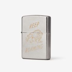 a lighter with the words keep roaming on it's side and a bear in the middle