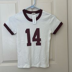 This Top Is Nwt, Meaning The Tag Hasn’t Been Removed From The T Shirt. It’s A Gorgeous T Shirt, And You Can’t Find It On Their Website, As Well As Their In Store Because It’s A Discontinued Piece. White Varsity Top For Spring, Retro White Tops For Game Day, White Varsity Fitted Top, Fitted White Top For Game Day, White Fitted Varsity Top, Varsity Fitted Top For Game Day, Retro Red Top For Game Day, Red Retro Top For Game Day, Brandy Melville Tee Shirt