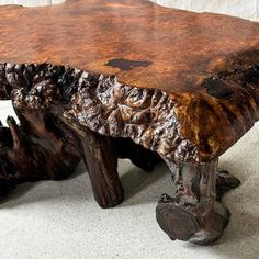 a wooden bench made out of tree trunks on the floor with white background and wallpaper