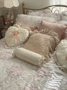 a bed with many pillows on top of it