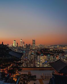 the city skyline is lit up at night