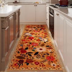 a kitchen with an orange rug on the floor