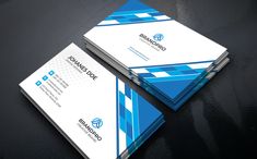 two business cards with blue and white stripes on the front, one is folded in half