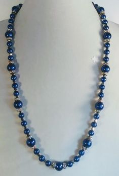 Handcrafted 27 Inch Necklace of Royal Blue Glass Pearls and Rhinestone Spacers There are also tiny silver Bicones between each bead and spacer.  The rhinestones are aurora borealis which add color and sparkle to this beautiful, classy necklace. A silver lobster claw clasp will hold everything secure, and the 2 inch extension chain will give you more length if you prefer it. Buy with confidence!  As with all of my work, your satisfaction is 100% guaranteed!! If you have questions or comments don't hesitate to contact us!  We look forward to hearing from you! Don't forget to check back often to see what is new! Enjoy! Thank you for stopping by! Have a great day! Blue Crystal Beaded Necklaces For Jewelry Making, Blue Crystal Round Beads, Blue Crystal Round Bead Jewelry, Blue Crystal Round Beads Jewelry, Blue Crystal Round Beaded Jewelry, Silver Beaded Necklace With Rhinestones, Silver Beaded Necklaces With Rhinestones, Blue Crystal Jewelry With Polished Beads, Gift Beaded Rhinestone Necklace With Round Beads