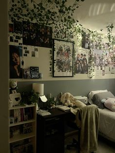 a dorm room with ivy growing on the wall and pictures above it, along with other decorations