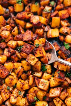 a pan filled with cooked potatoes and garnished with parsley