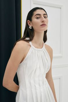 The Lucania halter dress in 100% Cotton is uniquely tapered at the waist with shaped box pleats giving the dress a flattering silhouette. The dress also has an invisible zipper and side pockets for ease of wear. Colour: Ivory Fit: Semi fitted silhouette (fitted at waist). Model is wearing a Size AU 8 Box Pleated Dress, Fashion Study, Black Dress Style, Garment Care Labels, 20s Fashion, Halter Maxi Dresses, Long Black Dress, Summer Design, Black Shirt Dress