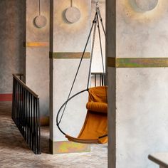 a hanging chair in the middle of a room