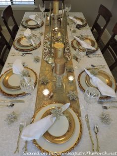 the table is set with white and gold plates