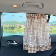 the curtains are hanging in the back seat of a car