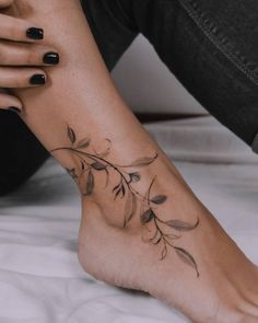 a woman's foot with leaves on it