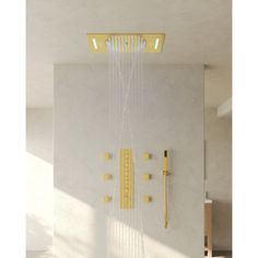 a shower head with yellow fixtures in a white walled room, next to a window