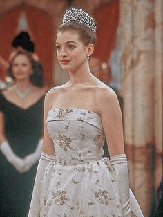 a woman in a white dress wearing a tiara