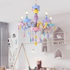 a child's room with a bed, toys and a chandelier