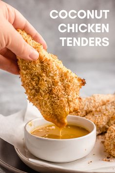 a person dipping chicken tenders into a bowl of sauce on top of a plate