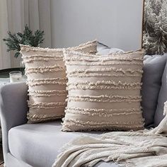 three pillows sitting on top of a couch