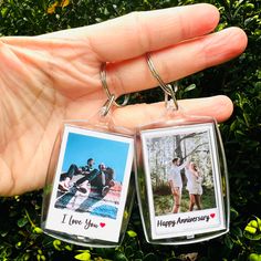 two key chains that have photos attached to them with the words i love you on them