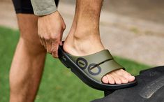 An evolution of the OOriginal, featuring an agile OOfoam™ strap for additionalsupport and comfort. Sport: Features bold, sporty, hand-painted graphics on the upper strap. | OOFOS Men's OOahh Sport Recovery Slide Sandal Size 7 in Tactical Green Sports Recovery, Tactical Clothing, Closed Cell Foam, Sport Sandals, Slide Sandals, Size 13, Evolution, Men's Shoes, Size 12