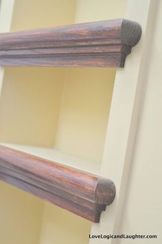 an old wooden shelf with two brackets on it