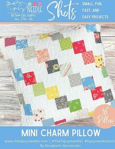 a quilted pillow with colorful squares on it and the words, mini charm pillow