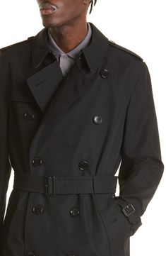 A classic double-breasted silhouette defines this mid-length trench crafted in the UK from water-repellent cotton gabardine and styled with a removable belt. Double-breasted button closure Notched lapels with hook-and-eye throat latch Belted cuffs Front button-welt pockets Gun flap Storm flap Back vent Removable belt Check-print lining 100% cotton Dry clean Made in the UK Men's Designer Clothing Designer Belted Outerwear For Business, Luxury Double-breasted Outerwear With Belt Loops, Belted Black Gabardine Outerwear, Black Belted Gabardine Outerwear, Classic Black Outerwear With Belted Cuffs, Classic Business Outerwear With Belted Cuffs, Classic Outerwear With Belted Cuffs, Classic Double-breasted Outerwear With Belted Cuffs, Classic Outerwear With Belt Loops For Business