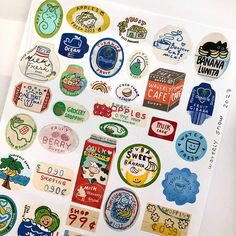 an assortment of stickers on a white surface