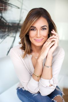 a beautiful woman sitting on top of a white couch