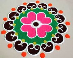 an image of a flower on the ground with orange and pink circles around it's center