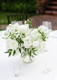 a vase filled with white flowers on top of a table