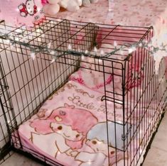 a baby bed in a cage with stuffed animals on the floor next to it and a hello kitty blanket