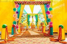 an outdoor wedding venue decorated in bright colors