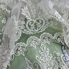 Beaded & Corded Bridal Lace Fabric Embroidered on 100% Polyester Net Mesh | Lace USA Elegant Lace Fabric With Machine Embroidery, Fitted Embroidered Cream Lace, Cream Embroidered Fitted Lace, Fitted Cream Embroidered Lace, Embroidered White Lace For Ceremony, Elegant Embroidered White Lace, Elegant Cream Embroidered Fabric For Ceremony, Elegant Fitted White Embroidered Fabric, White Embroidered Fabric With Lace Trim