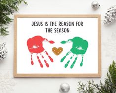 a christmas card with two handprints that say jesus is the reason for the season