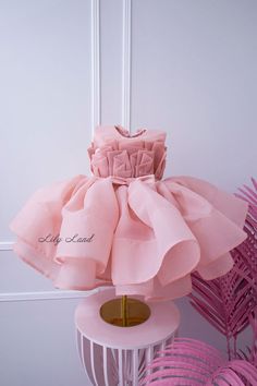 This beautiful blush tutu first birthday baby girl dress is the perfect choice for any little princess's special day. Crafted from high-quality tulle fabric, this puffy dress is designed to provide a comfortable and stylish fit for your little one. Whether she's attending a first birthday party or serving as a flower girl, this dress is sure to make a statement. The delicate floral embellishments and elegant design create a stunning and sophisticated look that will have everyone talking. Your li Elegant Organza Princess Dress For Birthday, Spring Pink Baptism Dress For Party, Spring Baptism Party Dress In Pink, Pink Tulle Dress For Party Baptism, Elegant Organza Dress For Birthday, Elegant Ruffled Tutu Dress For Birthday, Elegant Ruffled Princess Dress For Birthday, Elegant Pink Baptism Dress For Spring, Elegant Ruffled Baptism Dress For Birthday