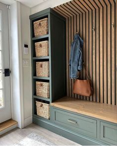 a wooden bench with baskets and a coat rack