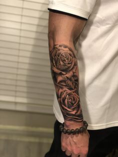 a man with a rose tattoo on his arm