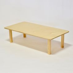 a wooden table sitting on top of a white floor