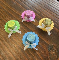 four different types of candy sitting on top of a wooden table