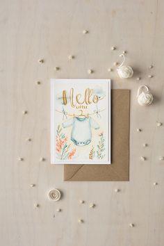 a greeting card featuring an illustration of a baby's body and name on it