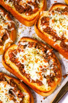 several pieces of bread with meat and cheese on top