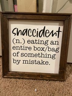 a framed sign that says snackin'n eating an entire box / bag of something by mistake