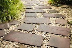 a walkway made out of stones and gravel