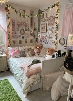 a bedroom decorated in pink and white with lots of stuffed animals