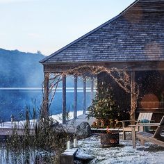 a gazebo sitting next to a lake covered in snow