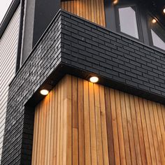 a black and wood building with lights on it